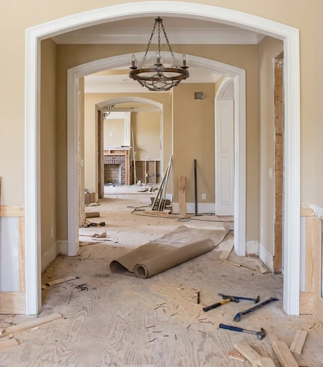 That hallway mid-renovation, subfloor bare and tools on the floor