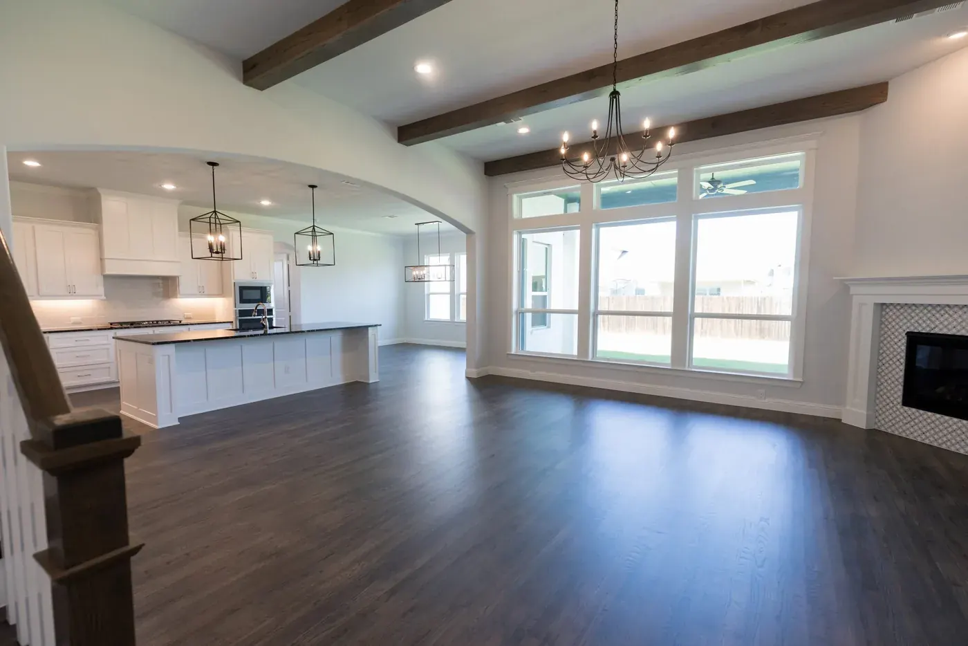 Engineered hardwood through an open kitchen and living area