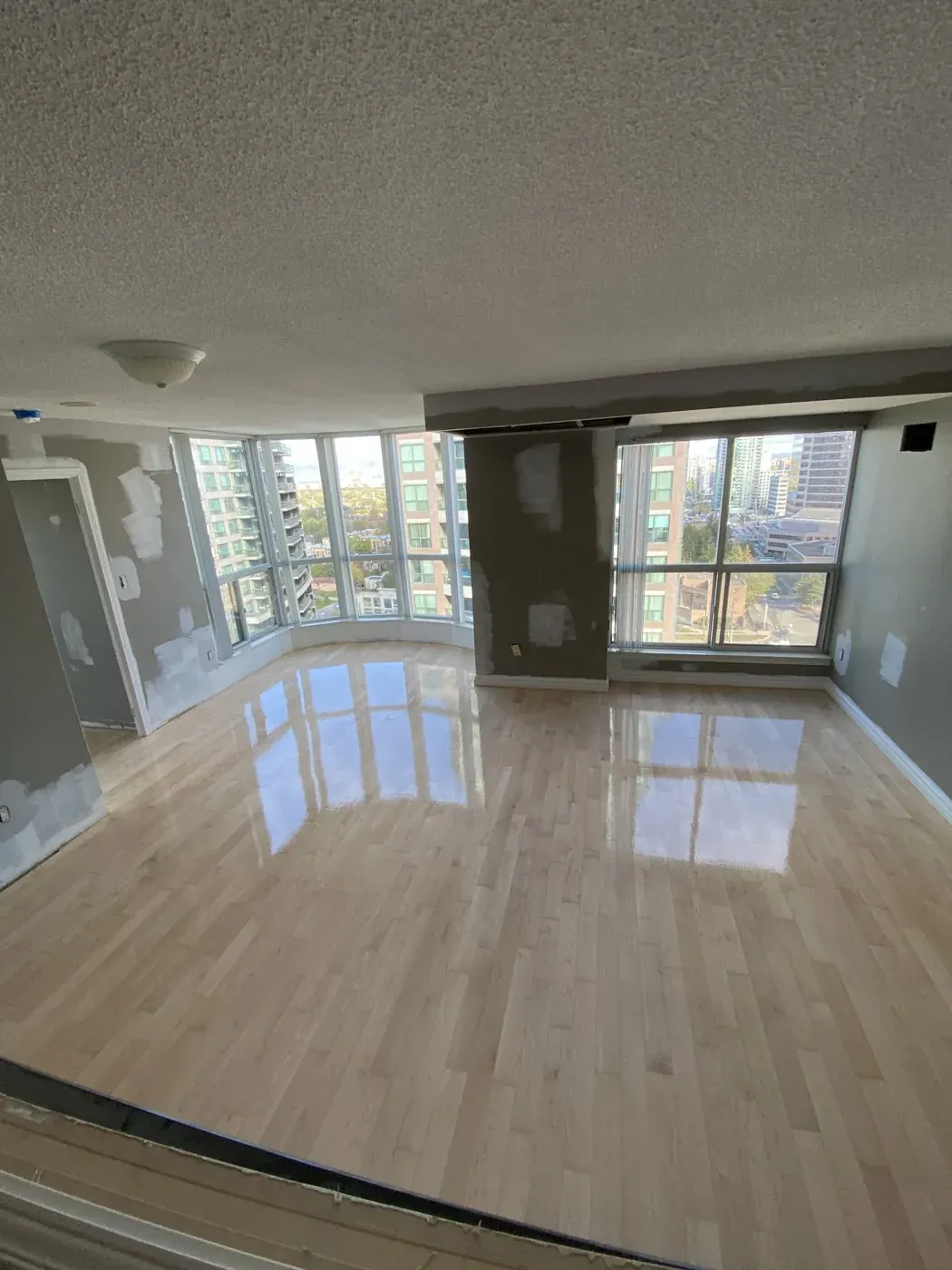Refinished hardwood floor in a condo living area