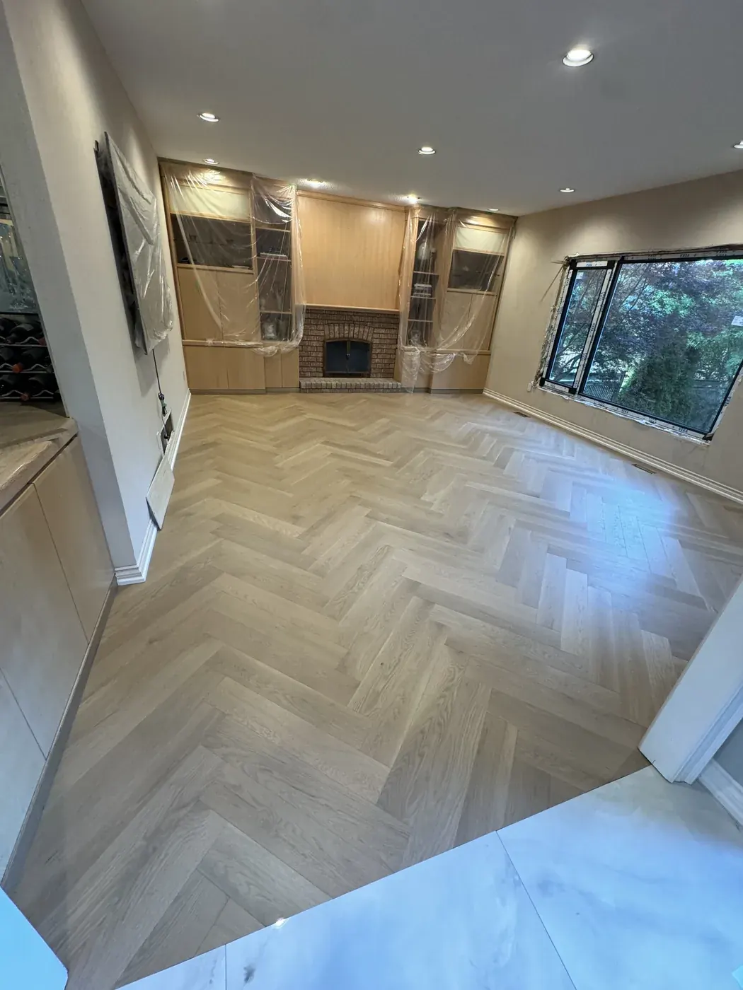 Herringbone hardwood across an open living room