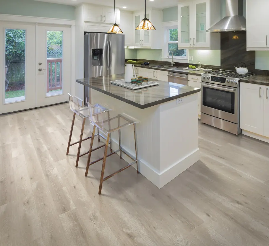 White kitchen with a pale grey wood-look laminate floor