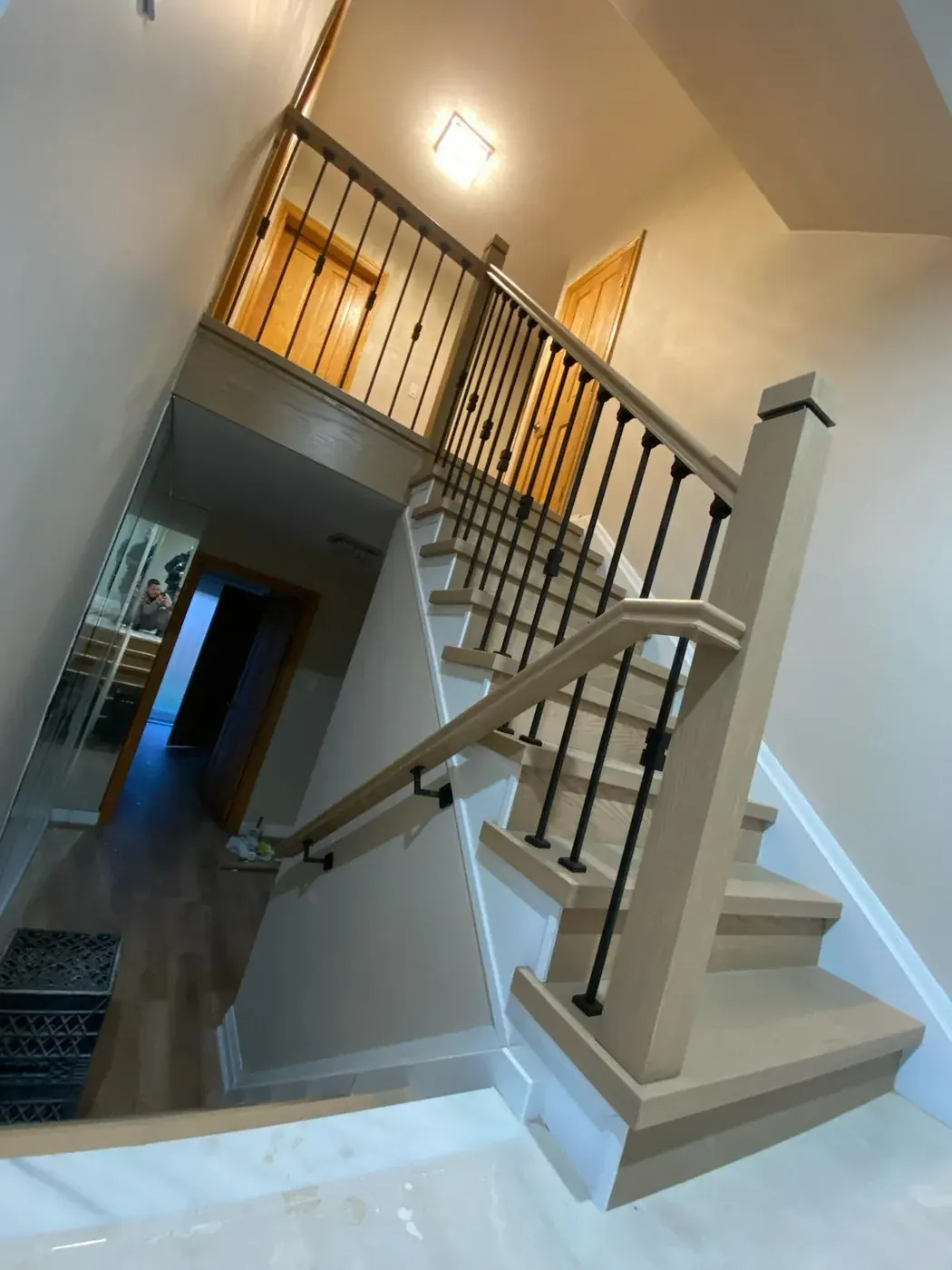 Rebuilt staircase with oak treads, a square post and iron pickets