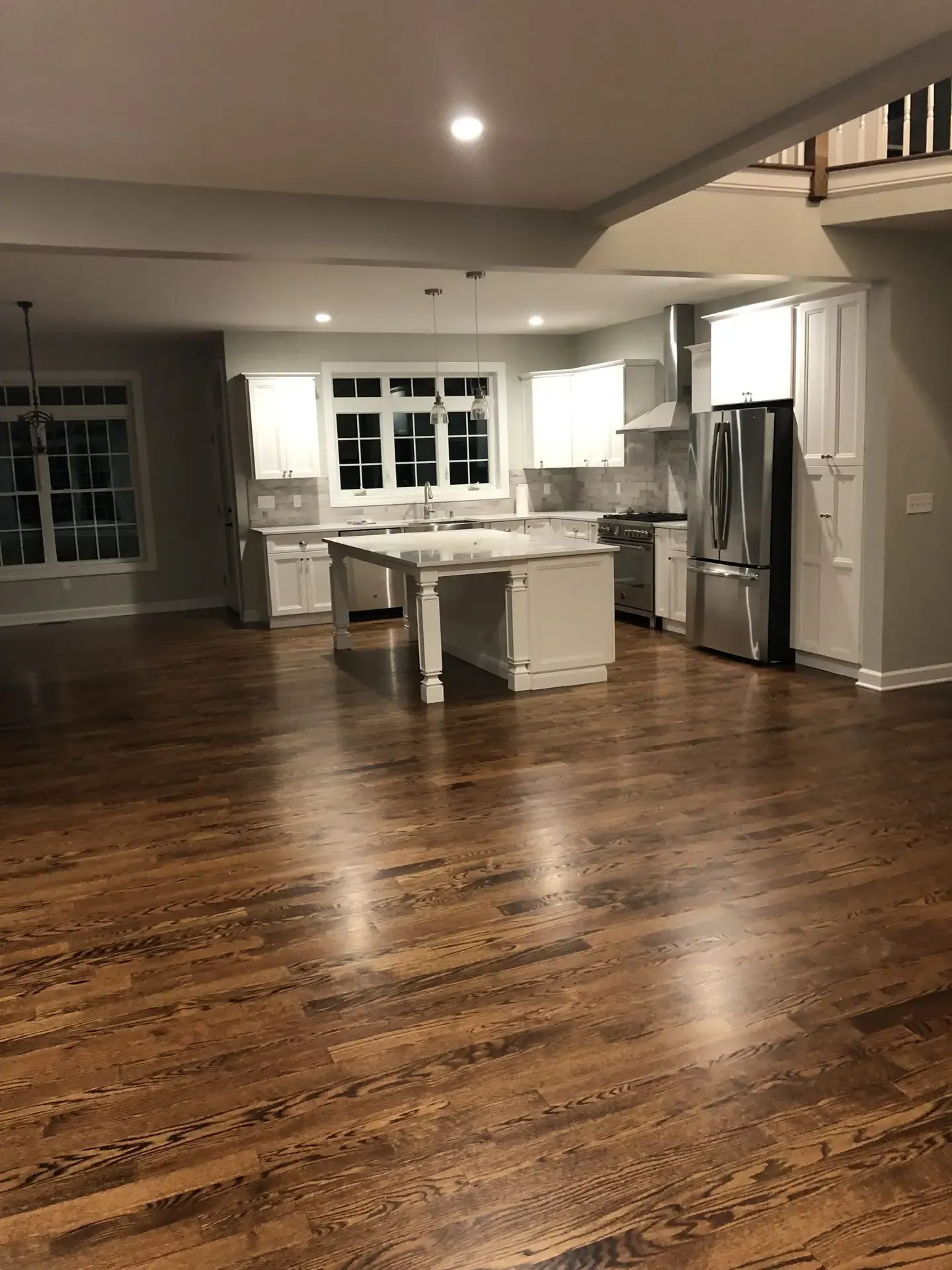Open kitchen with refinished dark hardwood