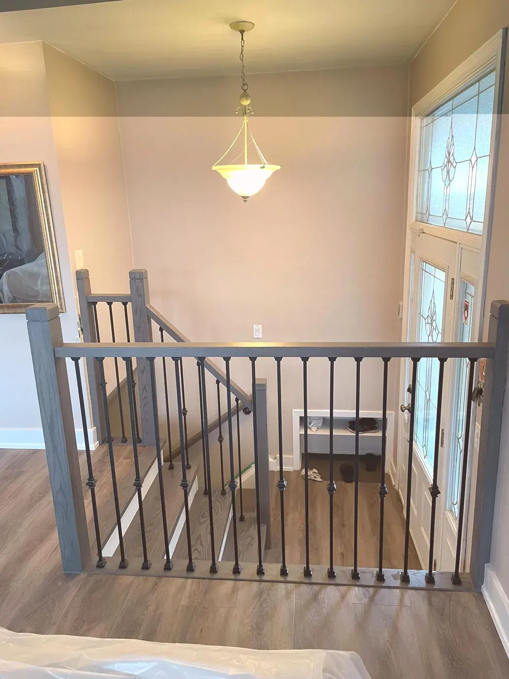 Upstairs landing with a grey railing and iron spindles