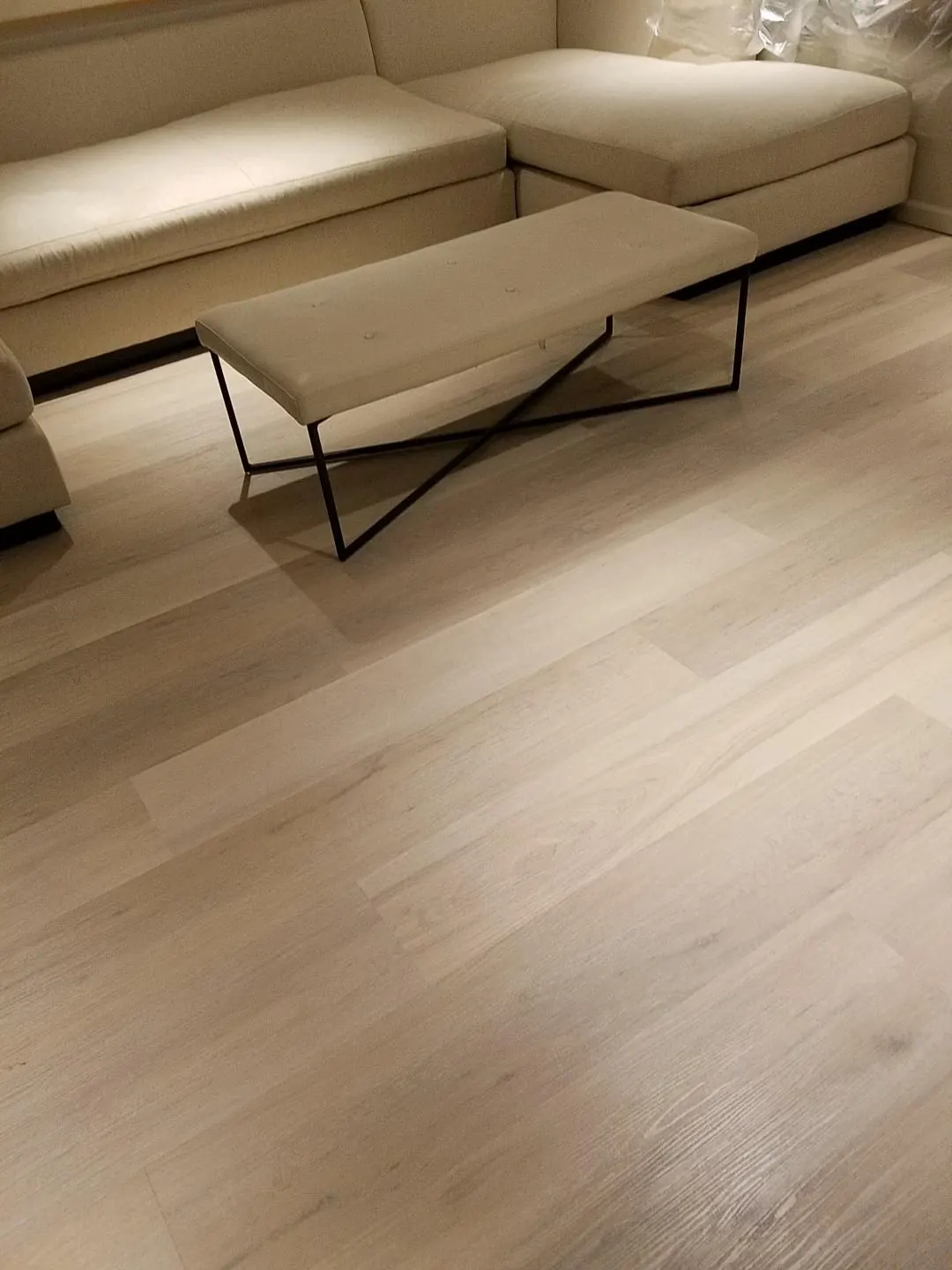 Wood-look vinyl plank beneath a coffee table, close up