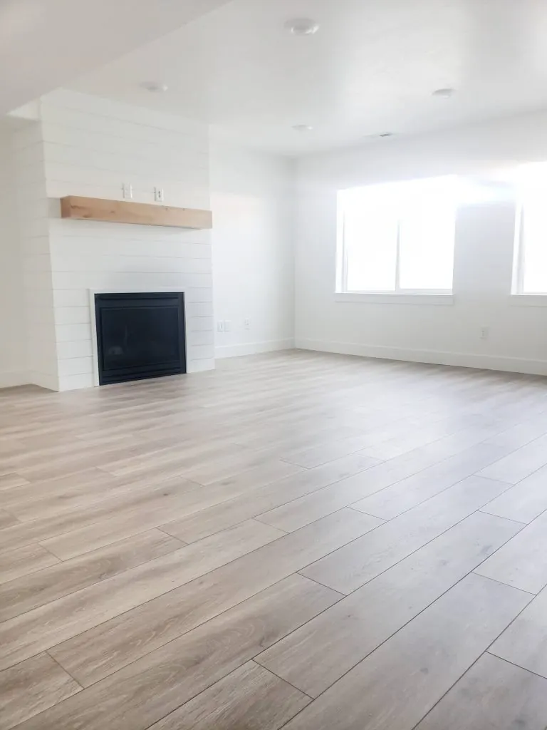 Living room and fireplace over light vinyl plank