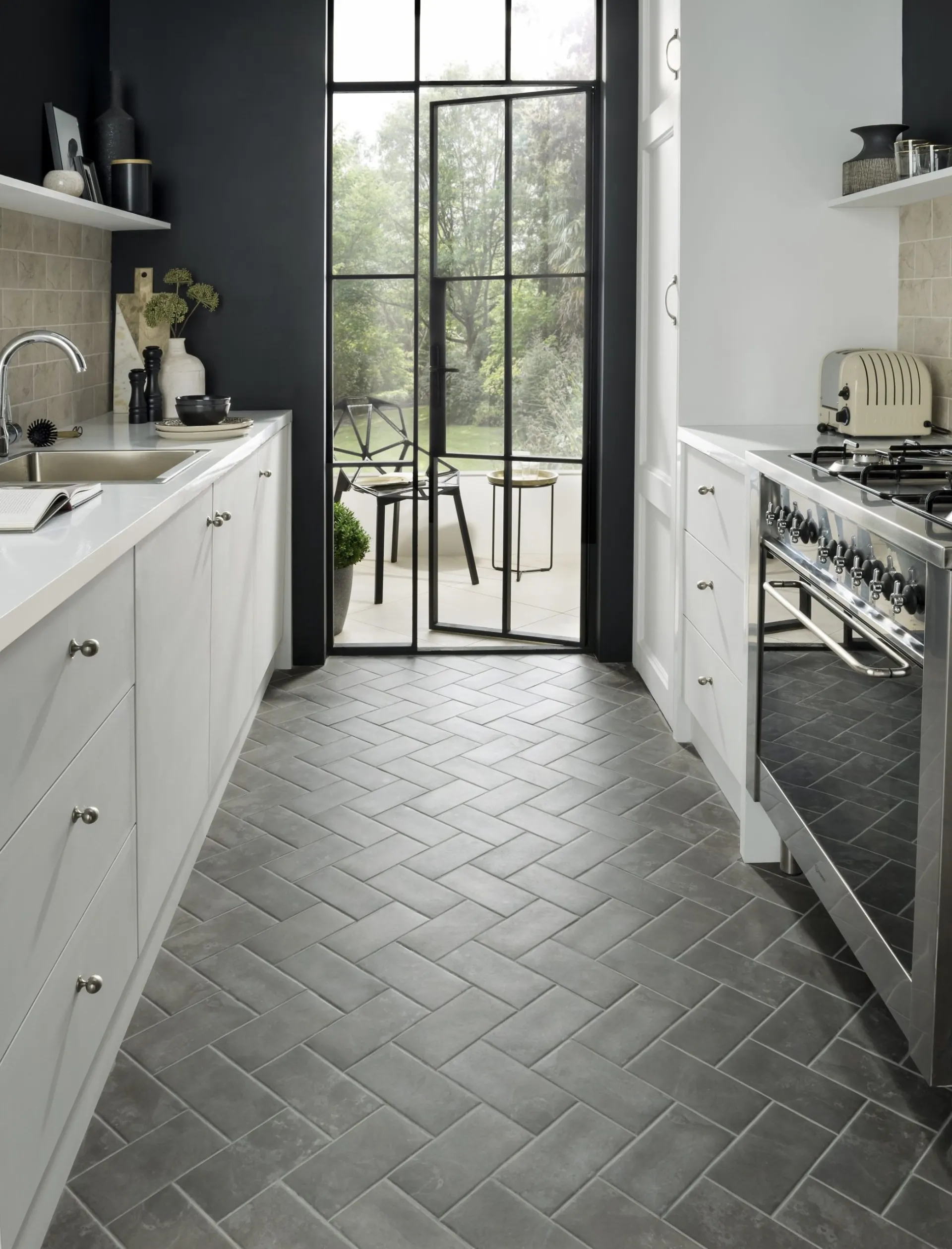 Galley kitchen with a grey herringbone tile floor