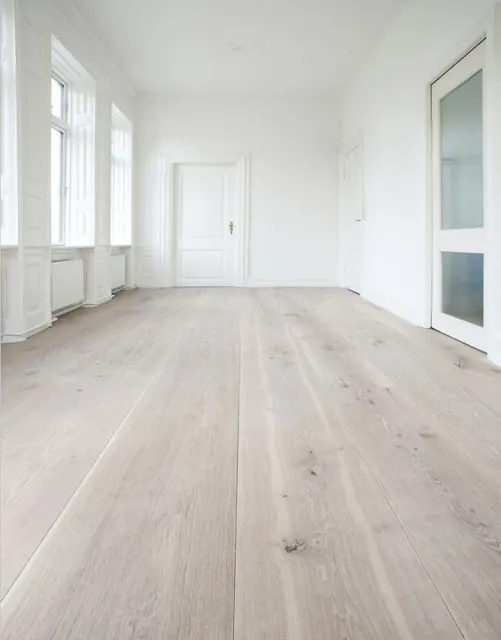 Empty bright room with pale oak-look vinyl