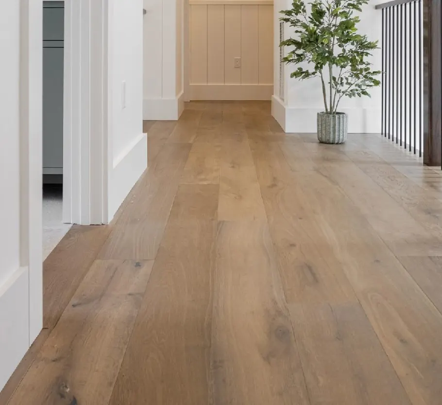 Oak plank floor in an upstairs hall beside a railing